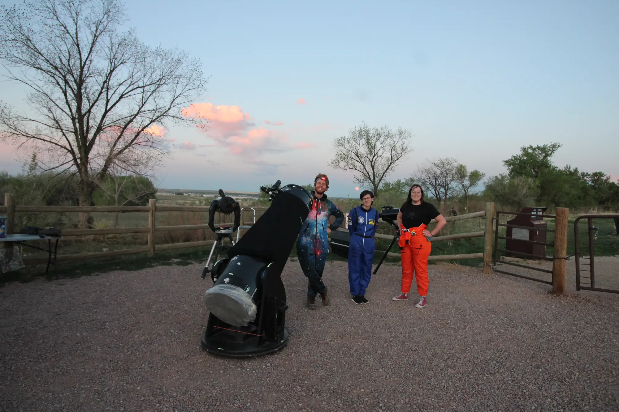 Astronomy guides with a large telescope at an outdoor observing site