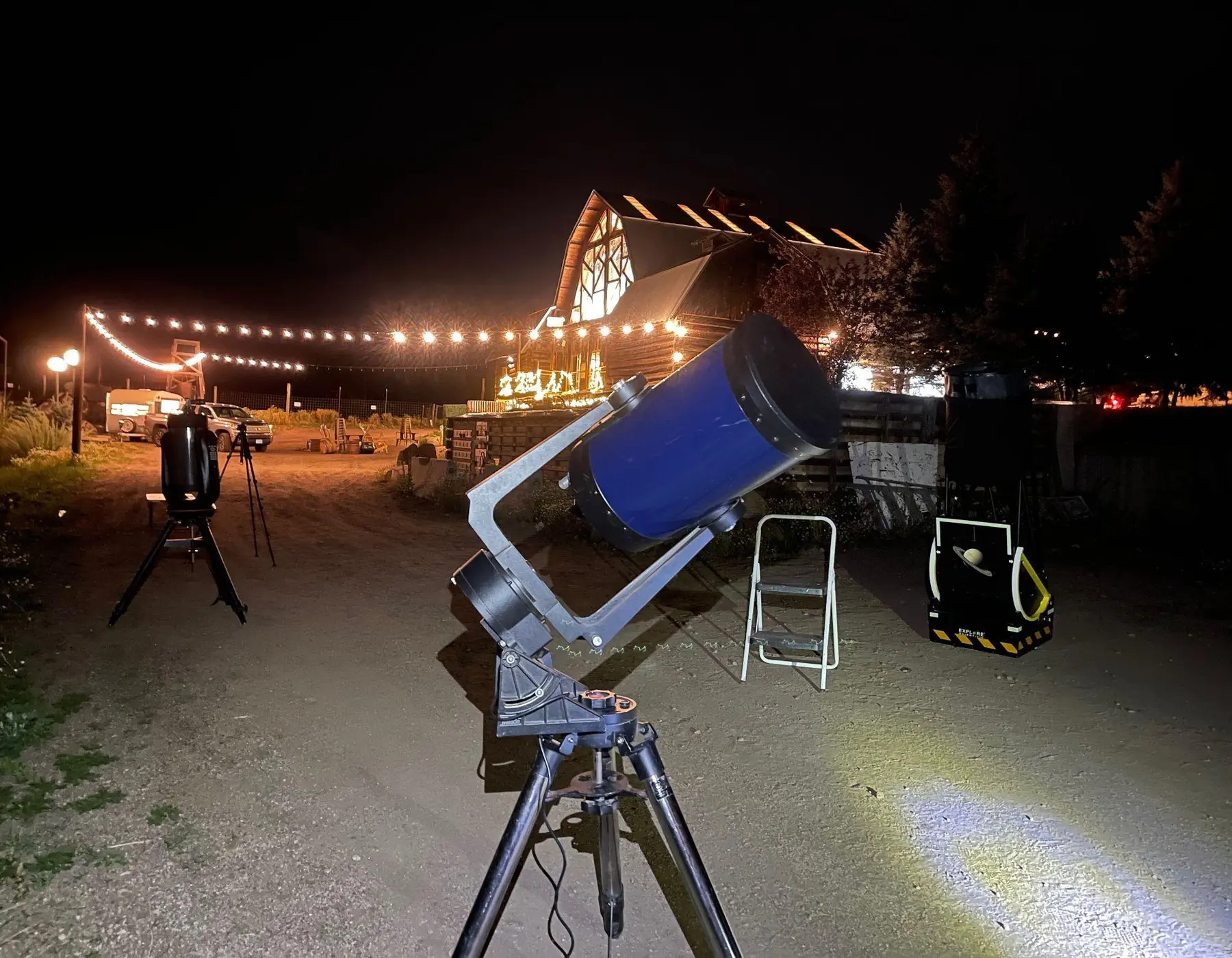 Large telescope set up outside a mountain hospitality venue for an evening guest program